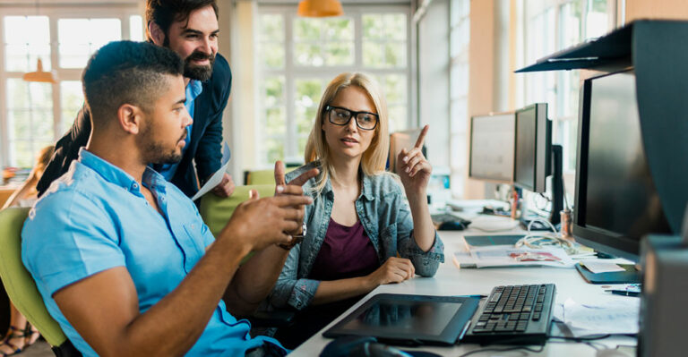 Diverse group of young colleagues making decision to buy a personal computer for business